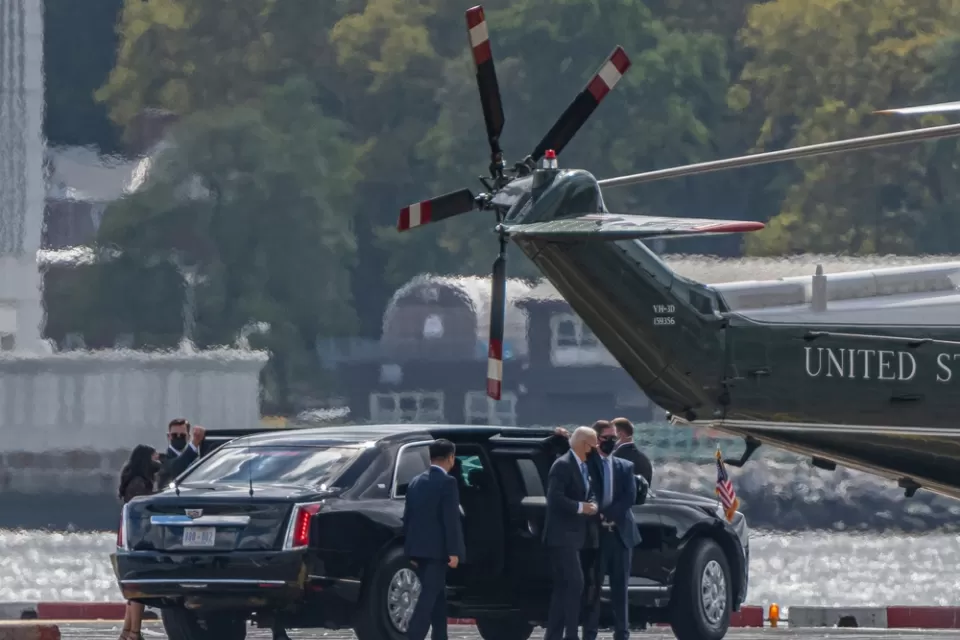 Joe Biden exits a limousine, surrounded by security and staffers, on the way to the Marine One helicopter on a pad near the water in New York City.